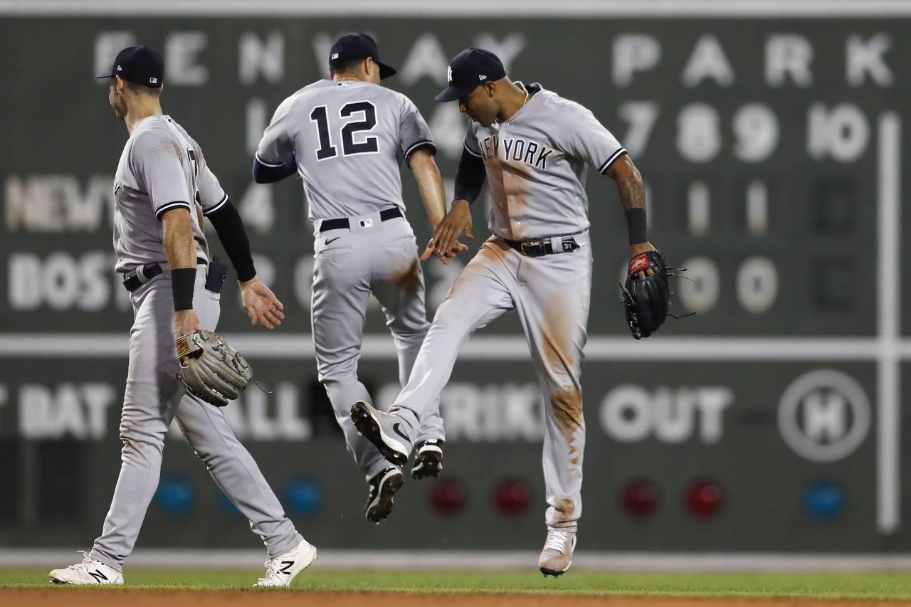 New York Yankees' Isiah Kiner-Falefa (12) and Aaron Hicks, right, celebrate after the team's win ov...