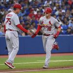 
              St. Louis Cardinals' Nolan Gorman, right, celebrates with third base coach Ron "Pop" Warner (75) after hitting a solo home run against the Toronto Blue Jays during the fifth inning of a baseball game Wednesday, July 27, 2022, in Toronto. (Jon Blacker/The Canadian Press via AP)
            