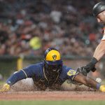 
              Milwaukee Brewers' Jonathan Davis scores next to San Francisco Giants catcher Joey Bart on a single by Willy Adames during the sixth inning of a baseball game in San Francisco, Thursday, July 14, 2022. (AP Photo/Godofredo A. Vásquez)
            