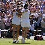 
              Tunisia's Ons Jabeur, right, embraces Germany's Tatjana Maria after beating her in a women's singles semifinal match on day eleven of the Wimbledon tennis championships in London, Thursday, July 7, 2022. (AP Photo/Kirsty Wigglesworth)
            