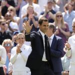 
              Former Wimbledon singles champion Roger Federer is applauded as he arrives to take part in a 100 years of Centre Court celebration on day seven of the Wimbledon tennis championships in London, Sunday, July 3, 2022. (AP Photo/Kirsty Wigglesworth)
            