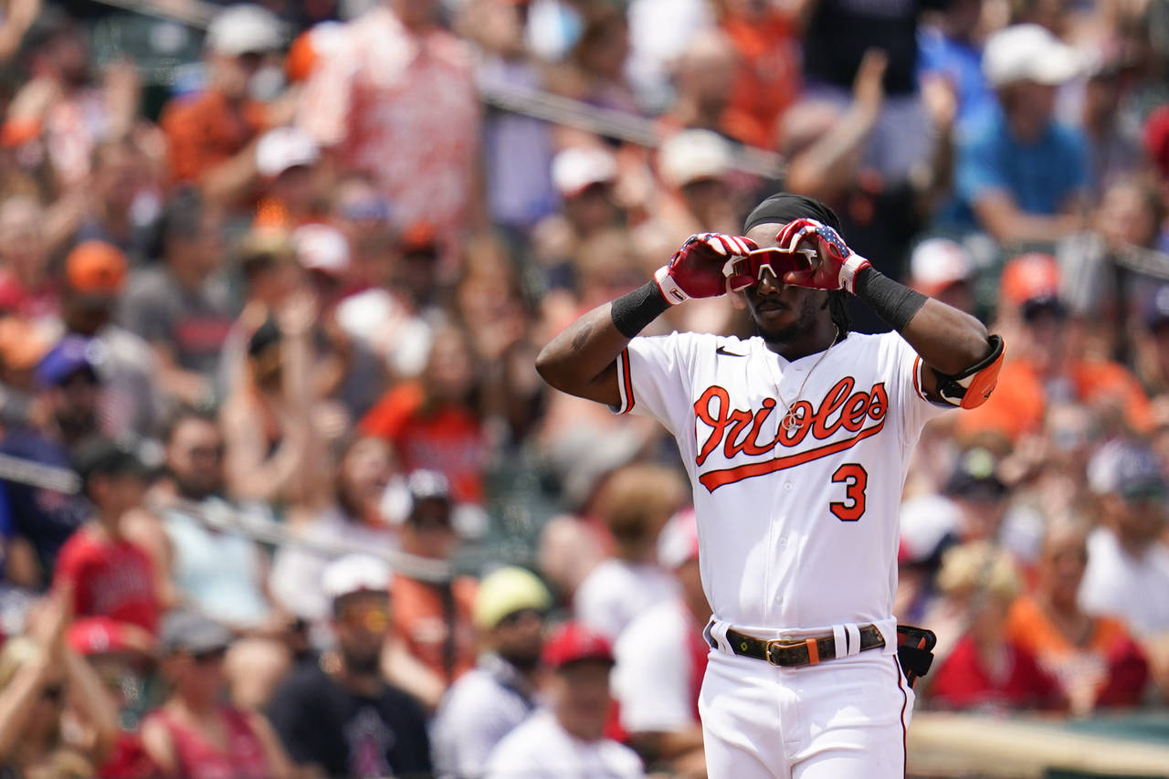 Baltimore Orioles' Jorge Mateo gestures toward his dugout after hitting a triple against the Los An...