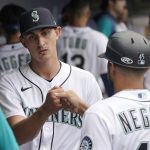 
              Seattle Mariners starting pitcher George Kirby, left, greets first base coach Kristopher Negron after the top of the sixth inning of the team's baseball game against the Oakland Athletics, Saturday, July 2, 2022, in Seattle. (AP Photo/Ted S. Warren)
            