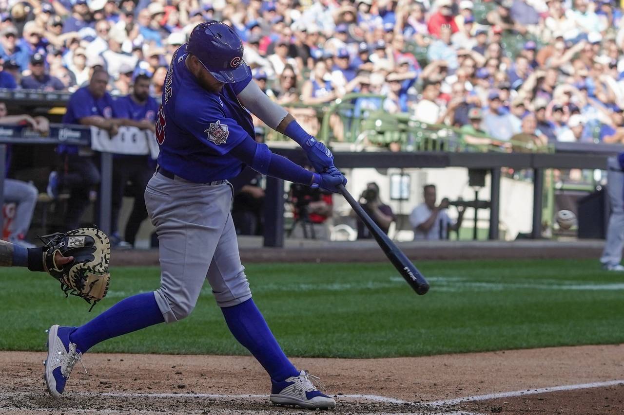 Chicago Cubs' P.J. Higgins hits an RBI double during the ninth inning of a baseball game against th...