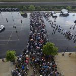 
              Lines of fans wait to go through added security at Guaranteed Rate Field after a Fourth of July parade shooting in nearby Highland Park, Ill., Monday, July 4, 2022, in Chicago before a baseball game between the Chicago White Sox and the Minnesota Twins. (AP Photo/Paul Beaty)
            