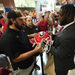 
              Georgia offensive lineman Sedrick Van Pran, right, signs autographs as he arrives for interviews during NCAA college football Southeastern Conference Media Days, Wednesday, July 20, 2022, in Atlanta. (AP Photo/John Bazemore)
            