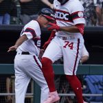 
              Chicago White Sox's Eloy Jimenez, right, celebrates with third base coach Joe McEwing after hitting a solo home run during the seventh inning of a baseball game against the Oakland Athletics in Chicago, Sunday, July 31, 2022. (AP Photo/Nam Y. Huh)
            