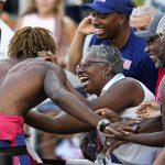 
              Noah Lyles, of the United States, greets fans after winning a final in the men's 200-meter run at the World Athletics Championships on Thursday, July 21, 2022, in Eugene, Ore. (AP Photo/Ashley Landis)
            