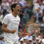 
              Taylor Fritz of the US celebrates after beating Australia's Jason Kubler in a men's singles fourth round match on day eight of the Wimbledon tennis championships in London, Monday, July 4, 2022. (AP Photo/Alastair Grant)
            