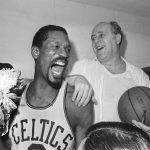 
              FILE - Boston Celtics' Bill Russell, left, holds a corsage sent to the dressing room as he celebrates with Celtics coach Red Auerbach after defeating the Los Angeles Lakers, 95-93, to win their eighth-straight NBA Championship, in Boston, in this April 29, 1966, photo. The NBA great Bill Russell has died at age 88. His family said on social media that Russell died on Sunday, July 31, 2022. Russell anchored a Boston Celtics dynasty that won 11 titles in 13 years. (AP Photo/File)
            