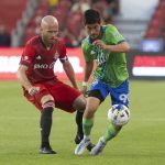
              Seattle Sounders midfielder Dylan Teves, right, takes the ball away from Toronto FC midfielder Michael Bradley during second-half MLS soccer match action in Toronto, Saturday July 2, 2022. (Chris Young/The Canadian Press via AP)
            