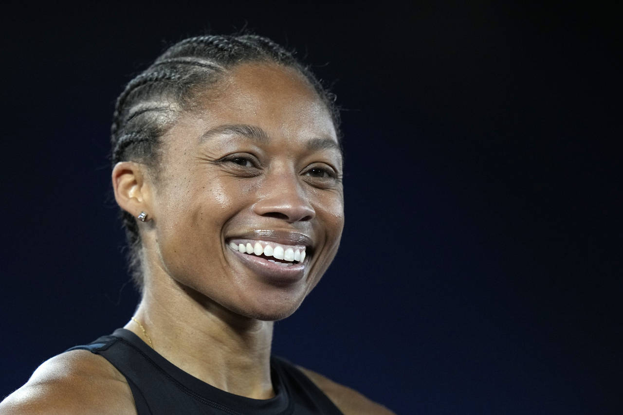 FILE - Allyson Felix of the United States smiles at the finish line of the women's 200-meter compet...