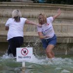 
              England supporters celebrate in a fountain in Trafalgar Square after watching their team win the final of the Women's Euro 2022 soccer match between England and Germany being played at Wembley stadium in London, Sunday, July 31, 2022. (AP Photo/Frank Augstein)
            