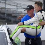 
              AJ Allmendinger, right, is placed back in his car by team manger Chris Rice after winning a NASCAR Xfinity Series auto race at Indianapolis Motor Speedway, Saturday, July 30, 2022, in Indianapolis. (AP Photo/AJ Mast)
            