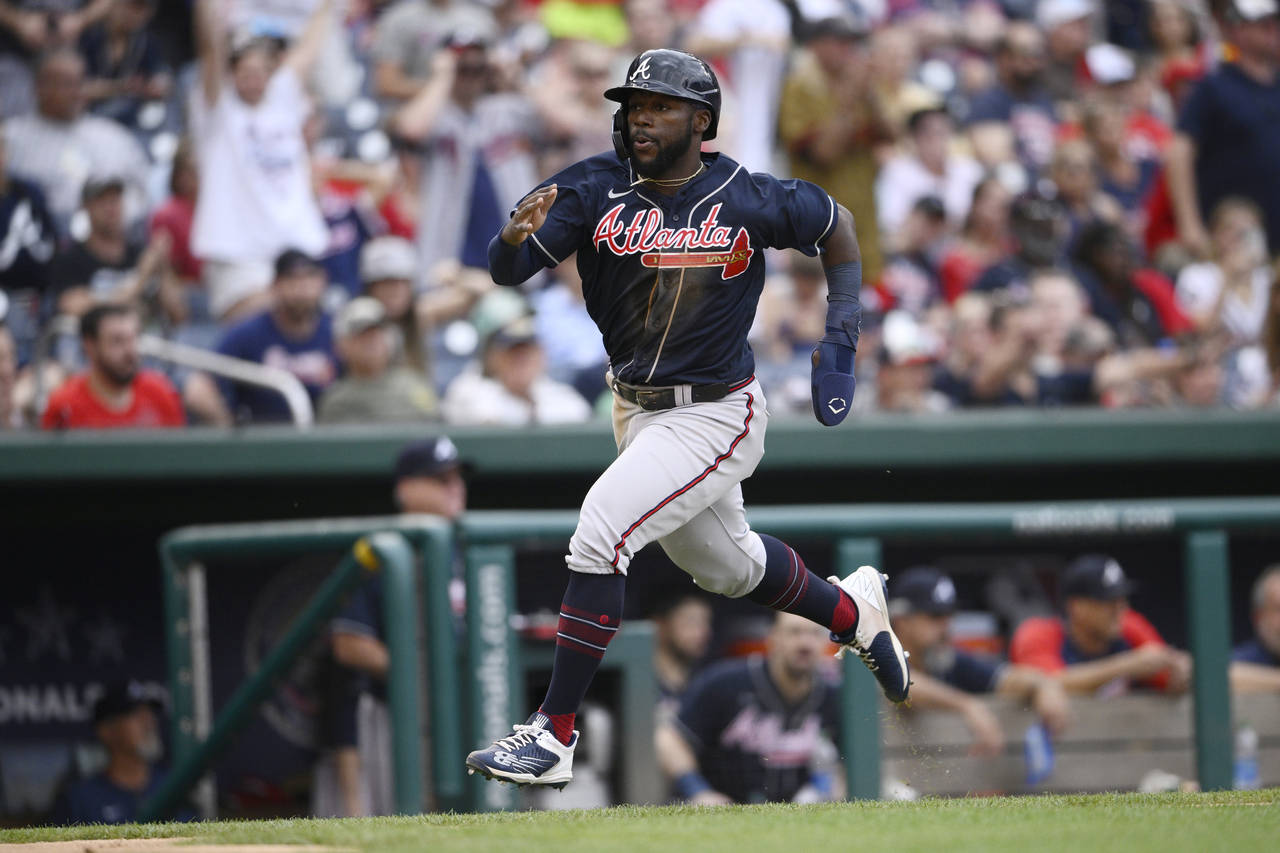 Atlanta Braves' Michael Harris II runs home to score on a double by Dansby Swanson during the seven...