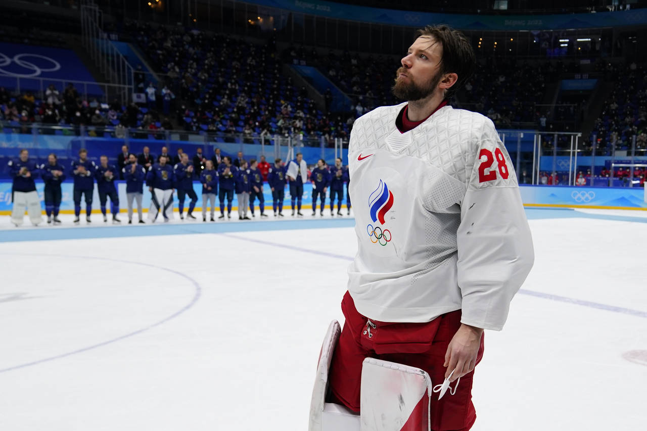 FILE - Russian Olympic Committee goalkeeper Ivan Fedotov (28) skates across the ice to receive his ...
