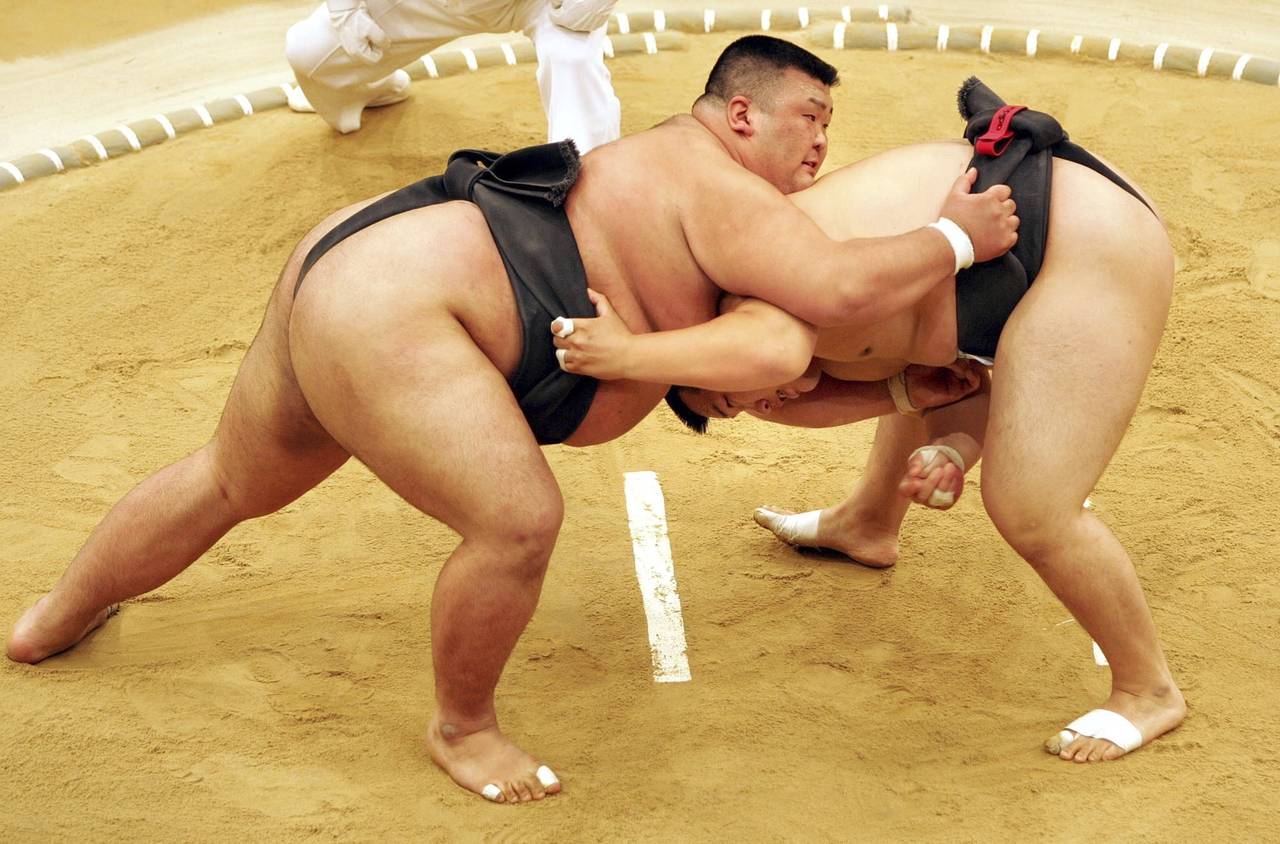 FILE - Sumo wrestler Takayuki Ichihara from Japan, left, fights against Keisho Shimoda from Japan, ...
