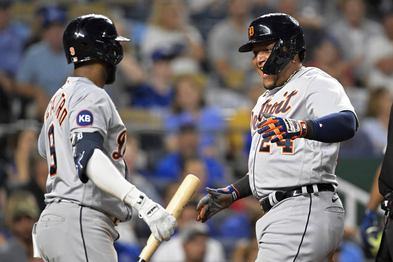 Detroit Tigers' Miguel Cabrera (24) celebrates scoring against the Kansas City Royals with teammate...