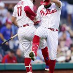 
              Philadelphia Phillies' Kyle Schwarber, right, and Rhys Hoskins celebrate after Schwarber's home run during the third inning of a baseball game against the Washington Nationals, Tuesday, July 5, 2022, in Philadelphia. (AP Photo/Matt Slocum)
            