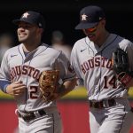 
              Houston Astros' Jose Altuve, left, and Mauricio Dubon, right, jog in after a baseball game against the Seattle Mariners, Sunday, July 24, 2022, in Seattle. (AP Photo/Ted S. Warren)
            