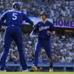 
              Los Angeles Dodgers' Trea Turner, right, is congratulated by Freddie Freeman as he scores after hitting a solo home run during the third inning of a baseball game against the San Francisco Giants Saturday, July 23, 2022, in Los Angeles. (AP Photo/Mark J. Terrill)
            