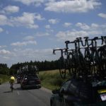 
              Belgium's Wout Van Aert, wearing the overall leader's yellow jersey rides past sport directors cars during the fourth stage of the Tour de France cycling race over 171.5 kilometers (106.6 miles) with start in Dunkerque and finish in Calais, France, Tuesday, July 5, 2022. (AP Photo/Daniel Cole )
            