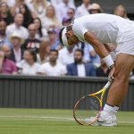 
              Spain's Rafael Nadal reacts after losing a point as he plays Taylor Fritz of the US in a men's singles quarterfinal match on day ten of the Wimbledon tennis championships in London, Wednesday, July 6, 2022. (AP Photo/Kirsty Wigglesworth)
            