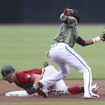 
              Arizona Diamondbacks' Josh Rojas, bottom, safely steals second base ahead of the tag from San Diego Padres shortstop C.J. Abrams, top, in the first inningof a baseball game, Sunday, July 17, 2022, in San Diego. (AP Photo/Derrick Tuskan)
            
