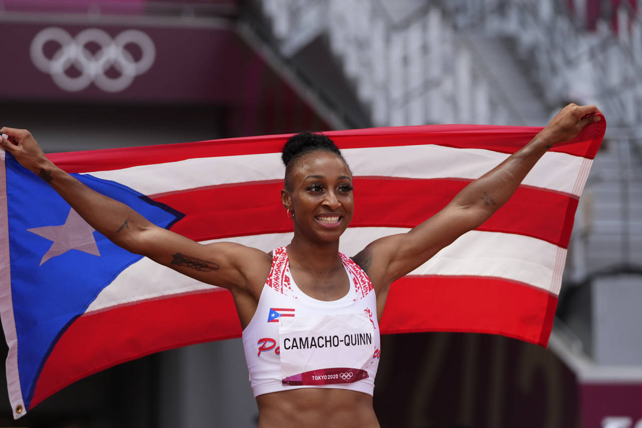 FILE - Jasmine Camacho-Quinn, of Puerto Rico, celebrates after winning the women's 100-meter hurdle...