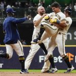 
              Milwaukee Brewers' Luis Urias is congratulated by teammates after hitting a walk off game-winning sacrifice fly during the ninth inning of a baseball game against the Minnesota Twins Tuesday, July 26, 2022, in Milwaukee. The Brewers won 7-6. (AP Photo/Morry Gash)
            
