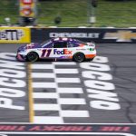 
              Denny Hamlin (11) crosses the finish line to win the NASCAR Cup Series auto race at Pocono Raceway, Sunday, July 24, 2022, in Long Pond, Pa. (AP Photo/Matt Slocum)
            