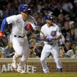 
              Chicago Cubs' Nico Hoerner, left, watches his RBI-double off Pittsburgh Pirates relief pitcher Yerry De Los Santos during the eighth inning of a baseball game Monday, July 25, 2022, in Chicago. (AP Photo/Charles Rex Arbogast)
            