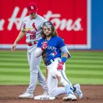 
              Toronto Blue Jays' Bo Bichette (11) gives a thumbs up after safely sliding into second base past St. Louis Cardinals shortstop Tommy Edman (19) for a double during the first inning of a baseball game, Tuesday, July 26, 2022 in Toronto. (Christopher Katsarov/The Canadian Press via AP)
            