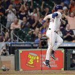 
              Houston Astros' Alex Bregman jumps up and grimaces after he scored on a wild pitch by Seattle Mariners reliever Andres Munoz during the eighth inning of a baseball game Thursday, July 28, 2022, in Houston. (AP Photo/Michael Wyke)
            