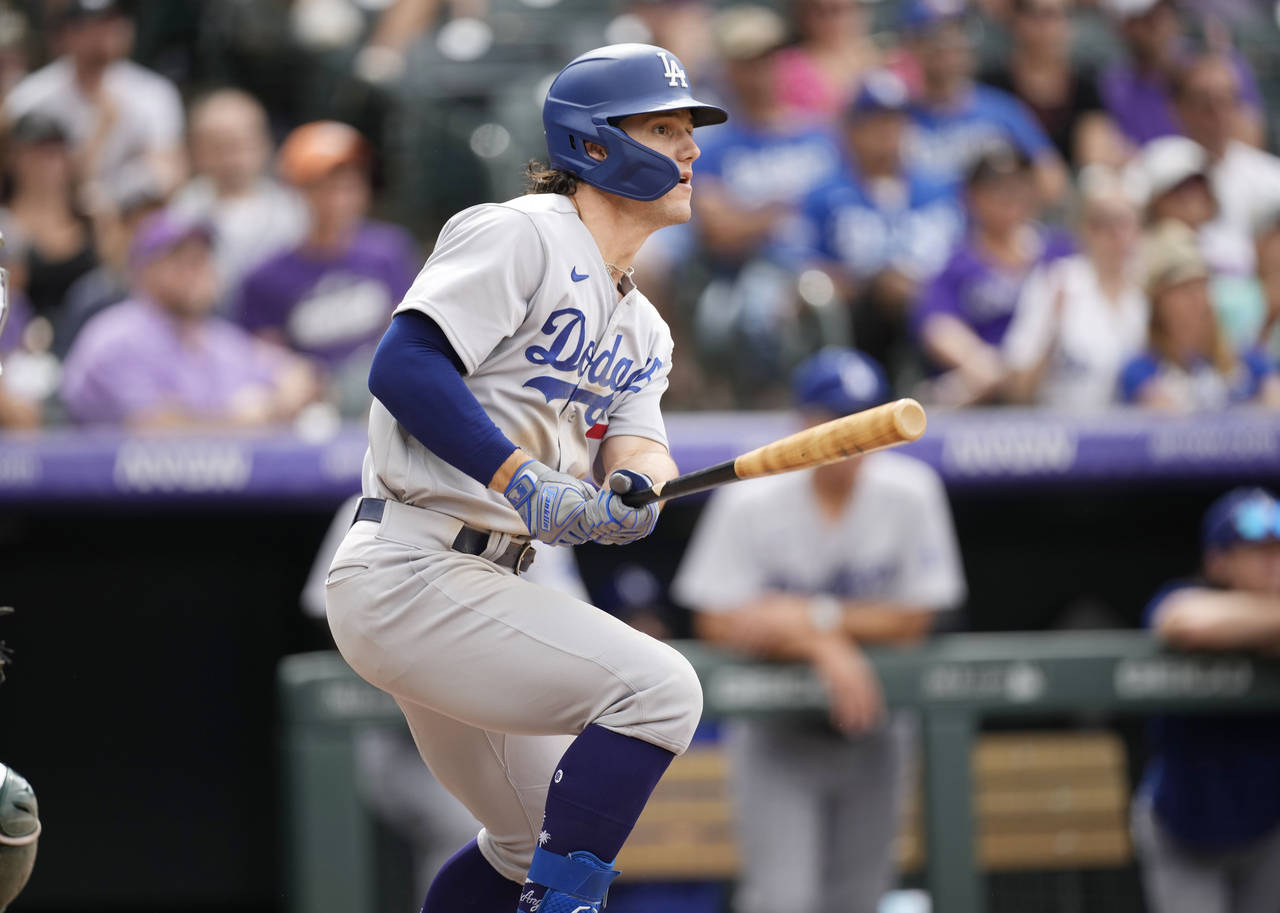 Los Angeles Dodgers' James Outman follows the flight of his RBI-double off Colorado Rockies relief ...