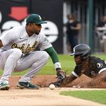 
              Chicago White Sox's Tim Anderson, right, steals second as Oakland Athletics shortstop Elvis Andrus is unable to handle the throw from catcher Sean Murphy during the first inning of a baseball game Saturday, July 30, 2022, in Chicago. (AP Photo/Charles Rex Arbogast)
            
