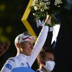 
              Slovenia's Tadej Pogacar, wearing the best young rider's white jersey, celebrates on the podium after the twenty-first stage of the Tour de France cycling race over 116 kilometers (72 miles) with start in Paris la Defense Arena and finish on the Champs Elysees in Paris, France, Sunday, July 24, 2022. (AP Photo/Daniel Cole)
            