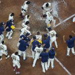 
              Milwaukee Brewers' Victor Caratini is congratulated after hitting a walk off three run home run during the 10th inning of a baseball game against the Chicago Cubs Monday, July 4, 2022, in Milwaukee. (AP Photo/Morry Gash)
            