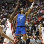 
              Oklahoma City Thunder's Aaron Wiggins (21) as Houston Rockets' Aric Holman defends during the second half of an NBA summer league basketball game Saturday, July 9, 2022, in Las Vegas. (AP Photo/David Becker)
            