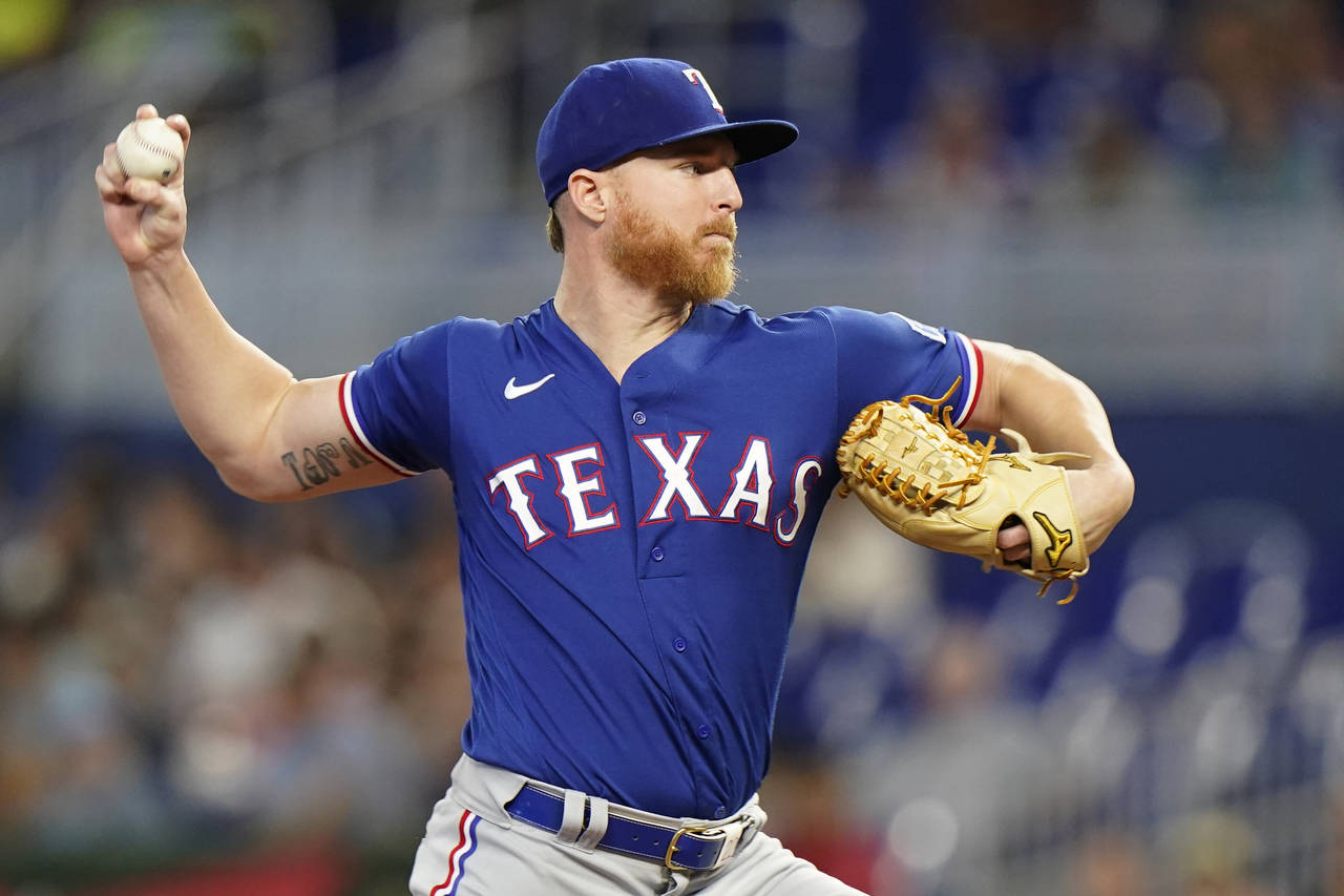 Texas Rangers' Jon Gray delivers a pitch during the first inning of a baseball game against the Mia...