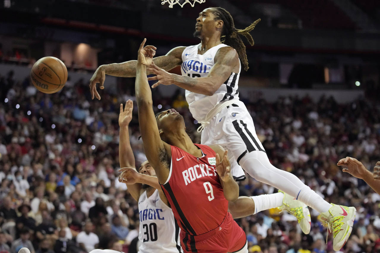 Orlando Magic's Emanuel Terry, right, blocks a shot by Houston Rockets' Josh Christopher during the...