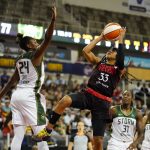 
              Indiana Fever guard Destanni Henderson (33) shoots over Seattle Storm guard Jewell Loyd (24) in the second half of a WNBA basketball game in Indianapolis, Tuesday, July 5, 2022. The Storm defeated the Fever 95-73. (AP Photo/Michael Conroy)
            