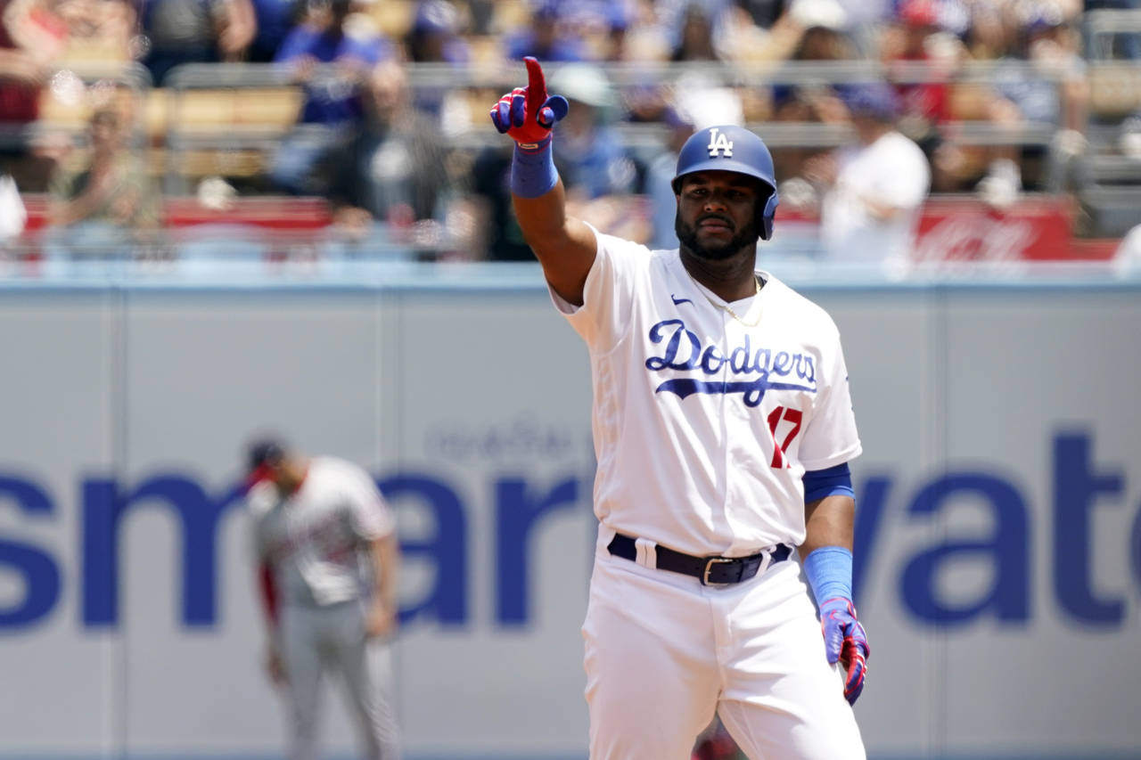 Los Angeles Dodgers' Hanser Alberto points to the dugout after driving in two runs with a double du...