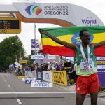 
              Tamirat Tola, of Ethiopia, celebrates after winning the men's marathon at the World Athletics Championships on Sunday, July 17, 2022, in Eugene, Ore. (AP Photo/Gregory Bull)
            