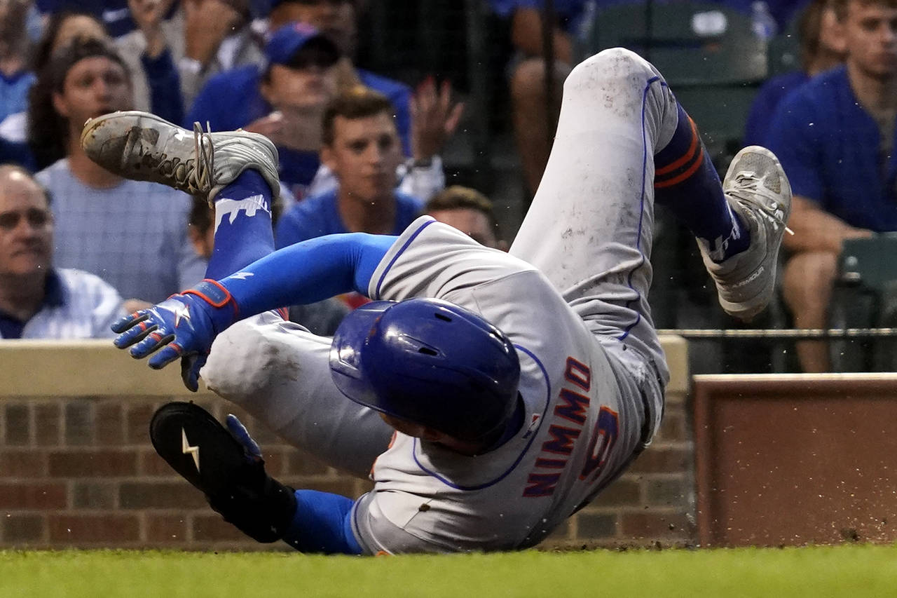 New York Mets' Brandon Nimmo scores against the Chicago Cubs during the third inning in the second ...