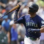 
              Seattle Mariners' Julio Rodriguez tosses his bat after hitting a three-run home run against the Texas Rangers during the seventh inning of a baseball game, Wednesday, July 27, 2022, in Seattle. (AP Photo/Ted S. Warren)
            