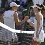 
              France's Alize Cornet, right, shakes hands with Poland's Iga Swiatek after defeating her in a third round women's singles match on day six of the Wimbledon tennis championships in London, Saturday, July 2, 2022. (AP Photo/Kirsty Wigglesworth)
            