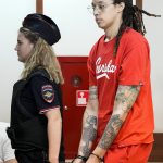 
              WNBA star and two-time Olympic gold medalist Brittney Griner is escorted to a courtroom for a hearing, in Khimki just outside Moscow, Russia, Thursday, July 7, 2022. Jailed American basketball star Brittney Griner returns to a Russian court on Thursday amid a growing chorus of calls for Washington to do more to secure her release nearly five months after being arrested on drug charges. (AP Photo/Alexander Zemlianichenko)
            