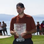 
              Tony Romo holds the championship trophy after winning the American Century Celebrity Championship golf tournament at Edgewood Tahoe Golf Course in Stateline, Nev., Sunday, July 10, 2022. (AP Photo/Tom R. Smedes)
            
