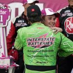 
              Christopher Bell is embraced by Martin Truex Jr., back to camera, after winning a NASCAR Cup Series auto race at the New Hampshire Motor Speedway, Sunday, July 17, 2022, in Loudon, N.H. (AP Photo/Charles Krupa)
            